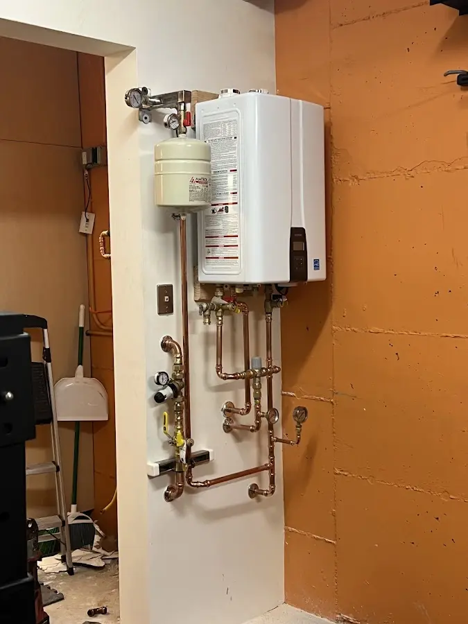 Plumbing technician inspecting water heater connections in La Mirada